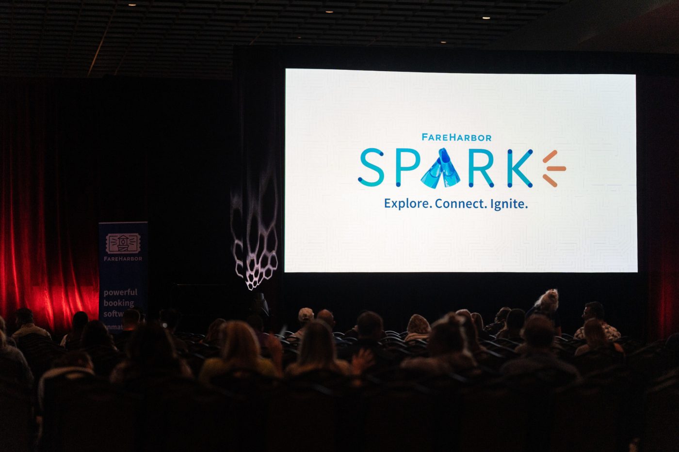 a group of people watching a band on stage in front of a crowd